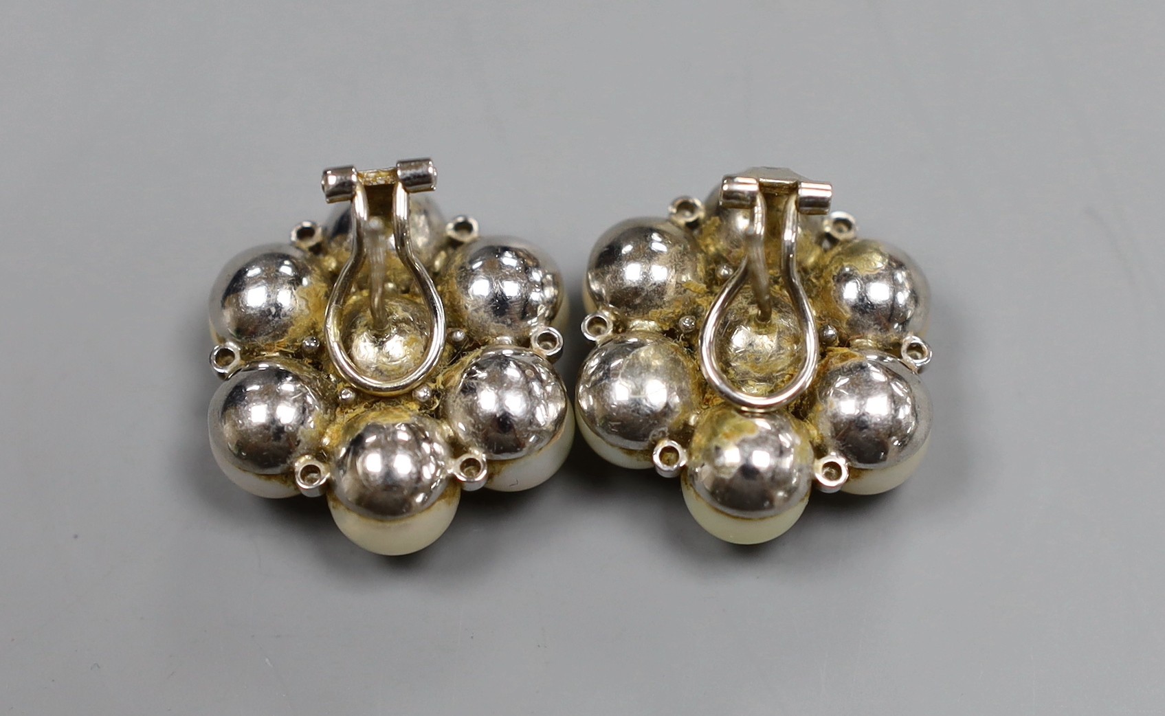 A pair of Indian white metal, cultured pearl and diamond chip cluster earrings, gross 22.7 grams, diameter 2.5cm